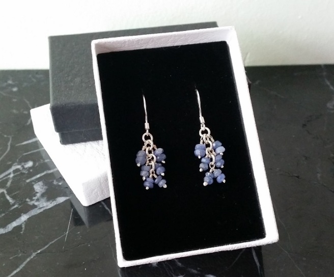 Blue sapphire cluster earrings in a black and white gift box