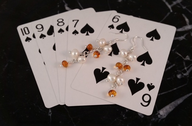 White pearl and cognac amber on a background of playing cards