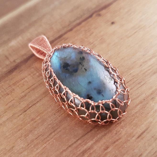 Labradorite oval wrapped in rose gold coloured wire