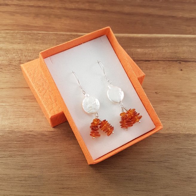 Amber and pearl earrings in an orange box