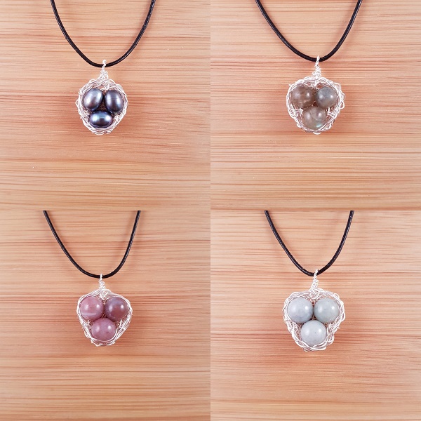 Four silver wire bird nest pendants with different coloured stones