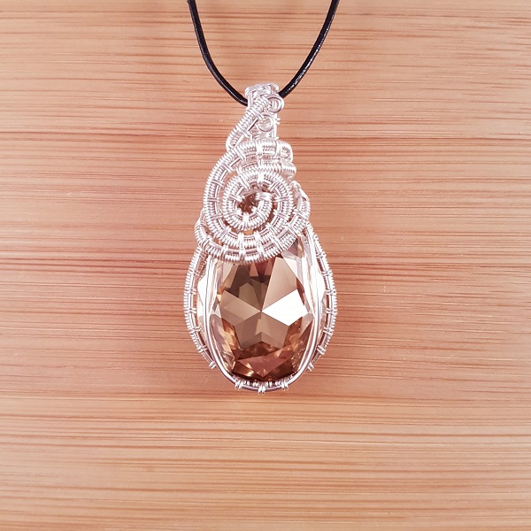 Golden Swarovski pear drop pendant wrapped in silver wire