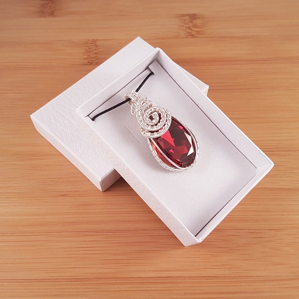 Silver wire wrapped red crystal pendant in white box